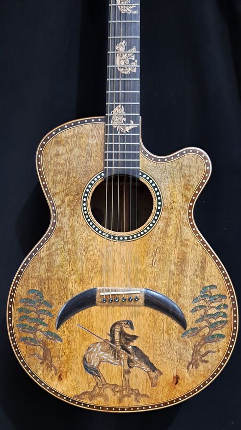 Blueberry Handmade Acoustic Guitar Grand Concert Native Motif New In Stock Blueberry Handmade Acoustic Guitars are made on the tropical island of Bali by our experienced team of traditional wood carvers and artisans who have been practicing their craft for generations.   Our unique workshop has been creating singular objects of musical and visual beauty since 2005.   This is your opportunity to own a unique instrument or to gift someone something that can be cherished for future generations.  If Painted Guitar Acoustic, Acoustic Guitar Design, Rustic Guitar, George Morris, Custom Acoustic Guitars, Guitar Inlay, Rare Guitars, Guitar Acoustic, Unique Guitars