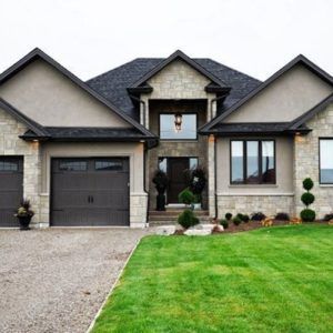 Tan House Dark Trim Exterior, Gray Black And Brown House Exterior, Beige House With Dark Trim Exterior, Dark Gray Trim Exterior House, Brown Grey House Exterior, Greige Stucco Exterior, Tan House Black Trim Exterior, Houses With Dark Trim Exterior, Black Roof Exterior Color Schemes