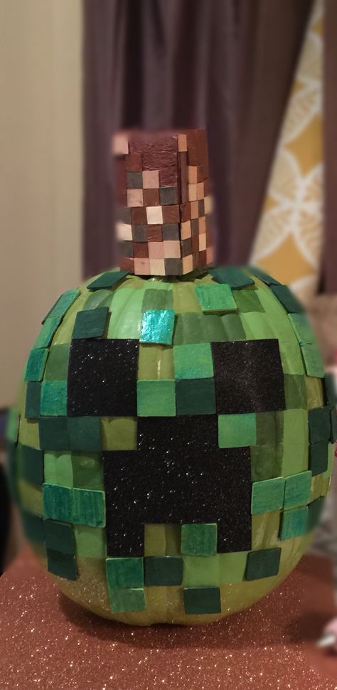 Minecraft decorated pumpkin using wooden tiles , green spray paint, craft paint and cardboard (for the stem) Minecraft Pumpkin Decorating, Minecraft Pumpkin Painting, Soccer Pumpkin Painting, Fortnite Pumpkin Painting, Minecraft Pumpkin, Pumpkin Show, Green Spray Paint, Character Pumpkins, Pumpkin Uses