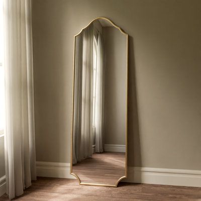 Dark with a bit of flair. This free standing, full length metal mirror provides a modern gothic aesthetic to your home! Perfect for bedrooms, dressing areas, and entryways - This tall beauty catches your body from head to toe so you can see your whole outfit with ease. Featuring an iron frame finished in a matte black to provide a timeless splash of dark style to any room its placed in! The dark finish encourages this mirror to blend in your home, while the touch of flair in the styling adds to Full Length Mirror On Closet Door, Full Body Mirror Entryway Ideas, Standing Mirror Corner Decor, Mirror For Dressing Room, Living Room Full Length Mirror, Mirror Stand Decor, Bedroom Floor Length Mirror, Tall Mirror In Bedroom, Full Length Mirror Bedroom