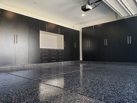 Salt and Pepper epoxy floor finish acts like a mirror for these gorgeous black cabinets! Black Garage Cabinets Ideas, Black Epoxy Garage Floor Ideas, Black Garage Cabinets, Black Epoxy Garage Floor, Sports Chiropractic, Garage Gym Flooring, Custom Garage Cabinets, Black Garage, Organization Systems