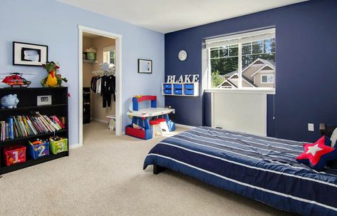 Kids bedroom with light blue walls and dark blue accent wall Light Blue Walls With Accent Wall, Two Tone Blue Bedroom Walls, Boys Bedroom Blue Walls, Accent Wall In Kids Bedroom, Baby Blue Accent Wall, Blue Room For Boys, Blue Boys Room Ideas, Dark Blue Kids Room, Blue Boys Bedroom Ideas