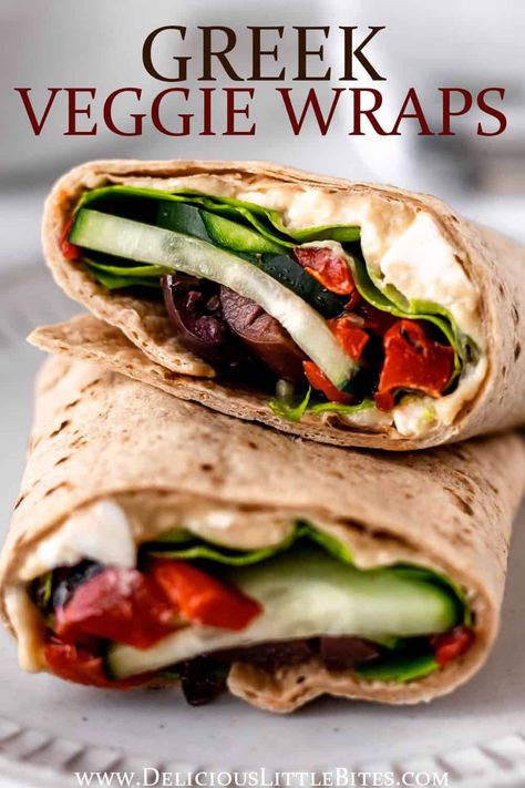 Packed with healthy vegetables, hummus and feta cheese, this vegetarian Greek Veggie Wrap is incredibly tasty! It's the perfect alternative to salad and quick enough to make for lunch on even the busiest of days. | #greekrecipes #greekfood #veggiewrap #wrapsandwich #vegetarian Best Veggie Wraps, Vegetarian Protein Wraps, Healthy Lunch Wraps Vegetarian, Mediterranean Wrap Recipes Vegetarian, No Meat Wraps Recipes, Tzatziki Wrap Vegetarian, Vegetarian Sandwich Wraps, Healthy Mediterranean Wraps, Easy Veggie Wraps For Lunch