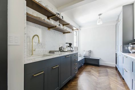 Reconfiguring the kitchen layout allowed Jeremy and Chris to extend the cabinetry and add an integrated refrigerator on one wall, so the opposite one could host a banquette, sink, and long open shelves. In addition to keeping the space from feeling too enclosed, the shelves show off the Carrara marble backsplash. Bathroom Sink Tile, Kitchen Without Upper Cabinets, Prewar Apartment, Integrated Refrigerator, Kitchen Vibes, Bathroom Mirror With Shelf, Recessed Medicine Cabinet, Herringbone Wood Floor, Herringbone Wood