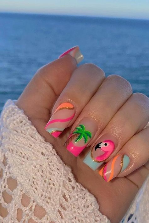 Embrace the tropical vibes with these almond-shaped summer vacation nails. A playful pink base is accented with a charming flamingo design, bringing a splash of vibrant personality. Swirling stripes of hot pink, pastel blue, and shining gold elegantly wrap across other nails, enhanced by a soothing palm tree motif that whispers the promise of relaxing beach days. The combination of pastels and lively hues make for a perfect summertime accessory. Beachy and chic! 🌴🦩  // Photo Credit: Instagram @nailsbykatyrose Tropical Holiday Nails Summer, Lilly Pulitzer Nails Designs, Tropical Nails French Tips, Palm Tree Design Nails, Christmas In Hawaii Nails, Love Island Nails, Nails For Beach Vacation Simple, Margaritaville Nails, Hot Summer Nails 2024