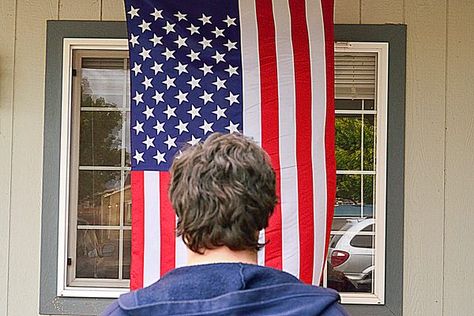 Display of the American flag is governed by the Federal Flag Code that explains, among other details, the rules for hanging a flag vertically. The regulations ensure that the flag is treated with respect as a symbol of national identity and pride. Most of the time, the flag is flown horizontally, but when it is practical or necessary to hang the... Flag Hanging Ideas Outside, Flag Hanging Ideas, American Flag On Porch, Flags On Wall, Flag On Porch, Gb Flag, Flag Code, Hanging Flags, Us Flags