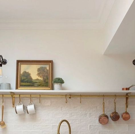 Perrin and Rowe on Instagram: "Whether your kitchen is small or spacious, open shelving offers a fresh and modern approach to storage, which combines aesthetics and functionality. Seen here in @little.leam.home, this beautifully serene kitchen incorporates open shelving and a utensil rail so essential tools are within arm's reach while also keeping worktops clutter free. Painted in @farrowandball Wimborne White, the kitchen includes our aged brass Ionian mixer and rinse along with our Parthia Open Shelving Brass Brackets, Kitchen Shelves With Brass Rail, Open Shelving With Brass Rail, Kitchen Shelf With Rail, Single Open Shelf Kitchen, Brass Rail Kitchen, Howden Kitchen, Kitchen Rail With Hooks, Kitchen Shelf Ideas