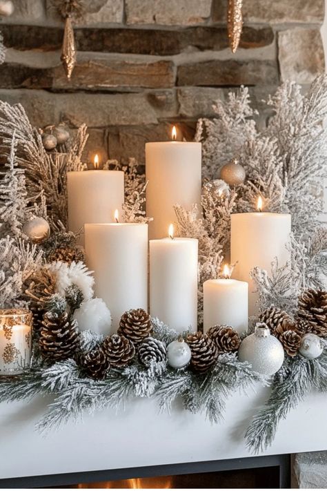 Lit white candles surrounded by frosted pinecones, silver ornaments, and snowy greenery on a mantelpiece. Winter Mantels, Winter Decorating, Home Cozy, Inviting Home, Winter Home Decor, Decorating On A Budget, Winter House, Pine Cones, Winter Decor