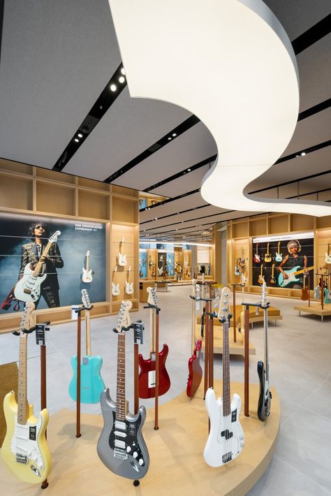 Music Store Interior, Glass Display Unit, Wooden Facade, Electric Guitar Design, Guitar Store, Led Video Wall, Vip Room, Curved Wood, Glass Facades