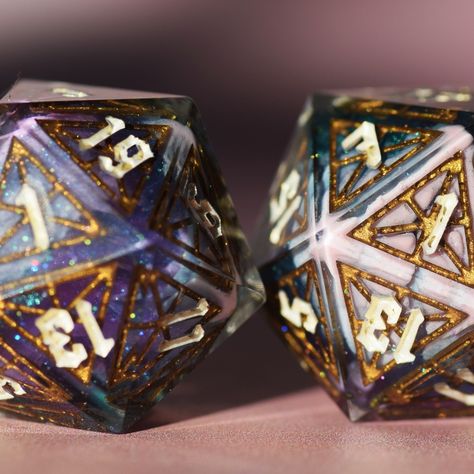 Mystra's Wanderer (Stained glass blanks version) This set is 10 pieces, the standard 7 plus an extra D20, a crystal D6 and a D2 :) This set was possible with masters from @atomic.dice and @druid_dice <3 #dice #diceset #polyset #diceofinstagram #polyhedraldice #handmadedice #ukdice #dicemaker #dnddice #tabletopdice #stainedglass #linework #intricatedice #intricate #windowdice #diceblanks #diceaddiction #criticalmissdice Crystals, Glass, Stained Glass, Resin Dice, Polyhedral Dice, Dnd Dice, 7 Plus, Table Top, Jade