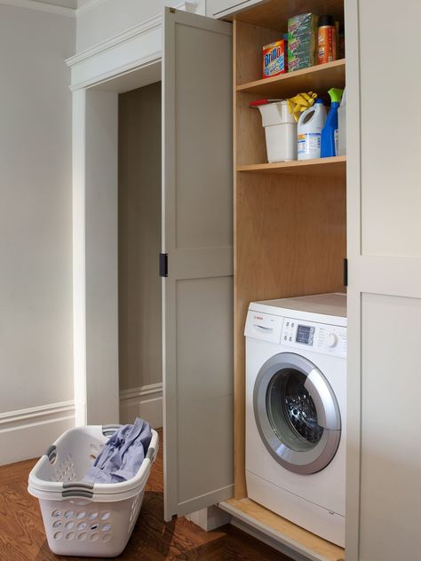 Fit a makeshift laundry room into a collection of cabinets, such as those in a kitchen, to hide these hardworking appliances in plain sight. The doors to this laundry area open and slide back into the cabinet, so they don't impede traffic flow. #laundryrooms #smalllaundryrooms #laundryroomideas #bhg Laundry Cupboard, Traditional Laundry Room, Simple Cabinet, Cabinetry Ideas, Laundry Doors, Laundry Shelves, Hidden Laundry, Small Laundry Room Organization, Laundry Room Doors