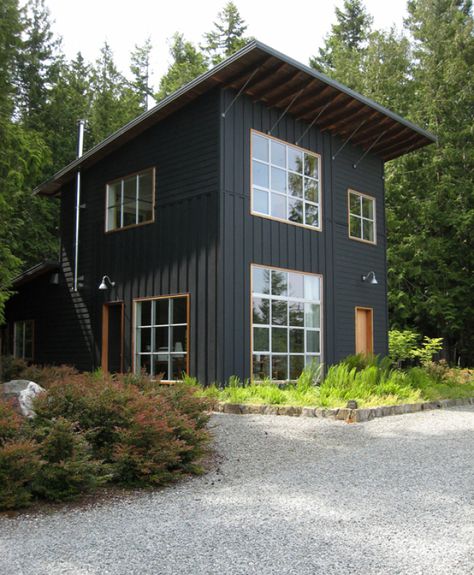 15 Modern Rustic Homes with Black Exteriors | upcycledtreasures.com Trees, Exterior, White Windows, Black House, A Black, Garage Doors, Shed, Dream House, Outdoor Structures