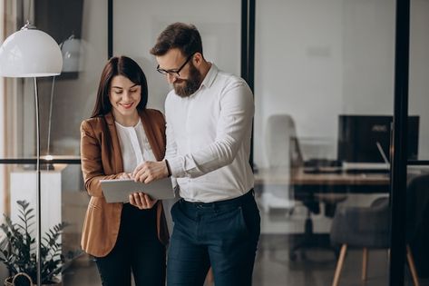 Two business partners working in office | Free Photo #Freepik #freephoto #business-couple #development-team #project-team #happy-office