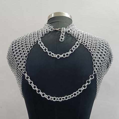 ❋ Chainmail Tops Now on Sale! ✨ Elevate your look with our stunning chainmail tops, now available at a special price! These unique pieces add a touch of metallic flair to any outfit, perfect for festivals, renaissance fairs, or everyday wear. • Website Link in Bio #chainmailtop #metallicfashion #festivalstyle #renaissancefair #statementpiece #shopnow Chainmail Epaulettes, Chainmail Outfit, Chainmail Projects, Chain Mail Top, Chainmaille Jewelry Patterns, Chain Outfit, Pearls Chains, Chainmail Top, Shoulder Piece