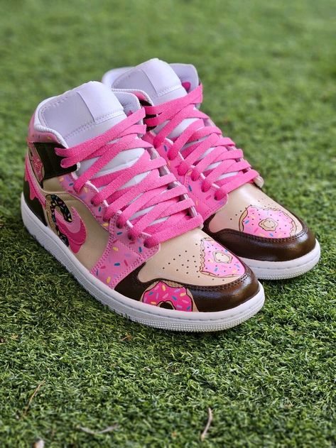 Step into a world of sweet style with our unique Hand-Painted Jordan Donut Sneakers! These custom sneakers are perfect for sneakerheads and donut lovers alike. Each pair is meticulously hand-painted with vibrant, high-quality paints, ensuring a one-of-a-kind piece of wearable art that stands out from the crowd. Each pair is custom hand-painted to order, making every shoe a unique piece of art. While we strive to match the colors and designs as shown, slight variations may occur due to the handcrafted nature of the process and the nuances of paint mixing and application. Custom Jordan 1 High, Diy Sneakers Designs, Custom Jordan 1, Custom Jordan Shoes, Donut Shoes, Painted Air Force 1, Jordan 1 Mids, Nike Shoes Women Fashion, Custom Sneakers Diy