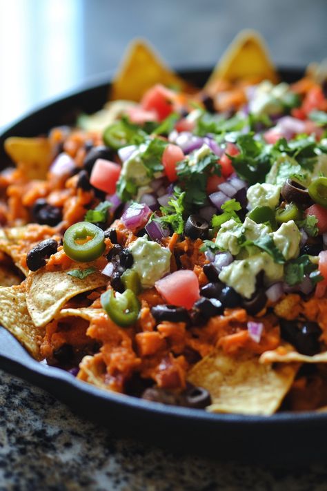 A plate of nachos topped with cheese, guacamole, jalapenos, tomatoes, black beans, red onions, and cilantro. Sweet Potato Bar Ideas, Sweet Potato Nachos Healthy, Potato Bar Ideas, Sweet Potato Bar, Potato Nachos Recipe, Nachos Healthy, Nacho Toppings, Potato Nachos, Homemade Nachos