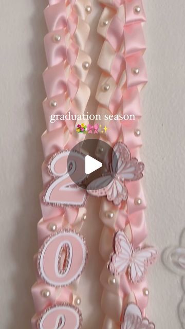 Pink Graduation Lei, Hello Kitty Lei, Coquette Grad Cap, Coquette Graduation Cap, Graduation Ribbon Leis, Graduation Lei Ideas, Cap Ideas For Graduation, Leis For Graduation, Graduation Vibes