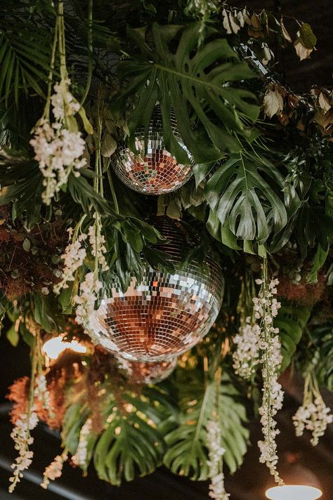 Tropical Palm Leaves with Disco Balls and Dainty White Flowers | Wedding Reception Dance Floor Installation Disco Balls And Palm Leaves, Eclectic Tropical Wedding, Disco Ball Tropical Wedding, White Flowers And Disco Balls, Disco Ball Tropical, Disco Balls Wedding Dance Floor, Enchanted Forest Disco, Flower Floor Decoration, Mamma Mia Wedding Reception