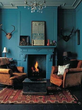 Intense deep teal walls and fireplace with earth brown and red furniture and accessories and antiques plus antlers Recording Studio Decor, Burnt Orange Living Room, Modern Bohemian Living Room, Turquoise Living Room Decor, Open Living Room Design, Living Room Turquoise, Moroccan Living Room, Boho Chic Living Room, Living Room Clocks