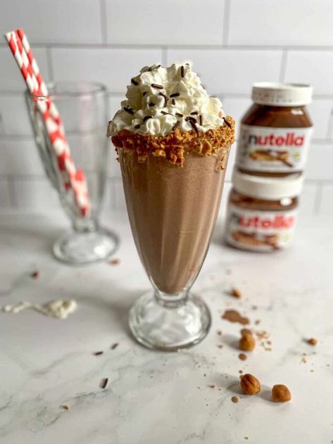 With only 3 ingredients, this Nutella Milkshake is a twist on a classic dessert! If you’re a Nutella lover, you’re in for a treat with this delicious milkshake recipe made with Nutella, ice cream, and milk. A rich and creamy chocolate hazelnut milkshake is a perfect sip on a hot summer day.Hungry for more Nutella recipes? You’ll love Nutella Stuffed Pancakes for a sweet breakfast! Or if you're looking for a healthy chocolate treat, a chocolate cherry smoothie or Snicker's smoothie shou… Nutella Milkshake Recipe, Nutella Drink, Dairy Free Nutella, Nutella Shake, Nutella Smoothie, Honey Kitchen, Healthy Chocolate Treats, Nutella Milkshake, Yummy Milkshake Recipes