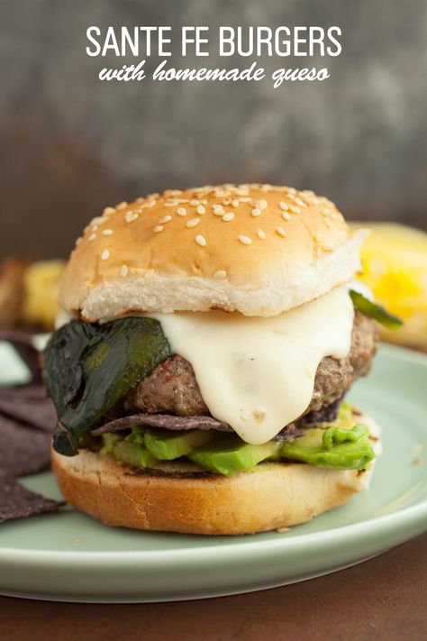 Santa Fe Burgers: One of my favorite burgers to toss on the grill in the summer. Topped with a spicy cheese sauce, roasted poblano peppers, and crispy blue corn chips! | macheesmo.com Santa Fe Burger, Poblano Burger, Chicken Sammies, Cooking Burgers, Mexican Burger, Gourmet Tacos, Salty Food, Roasted Poblano Peppers, Hamburgers Grilled