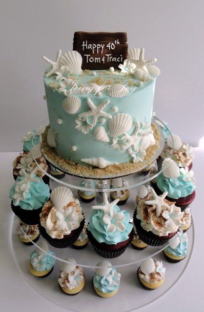 I like how this incorporates cake and cupcakes on the same stand! Ocean Themed Baked Goods, Coastal Birthday Party, Coastal Cake, Shell Cake, Cake With Cupcakes, Beach Cupcakes, Cupcakes Wedding, Beachy Theme, Summer Wedding Cakes