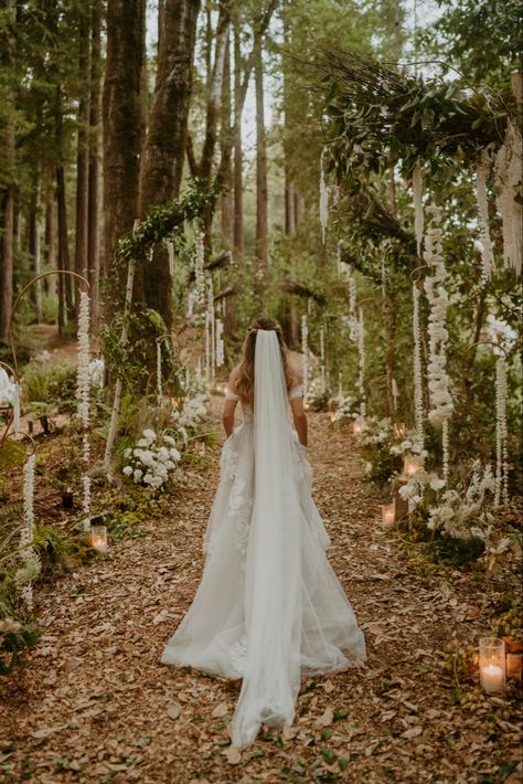 Girl walking up the aisle in forest for wedding Forest Wedding Wedding Dress, Utah Forest Wedding, Wedding Forest Ceremony, June Forest Wedding, Wedding In The Woods Dress, Outdoor Wedding In The Woods, Twilight Inspired Makeup, Alter Ideas For Wedding, Whimsical Forest Wedding Dress