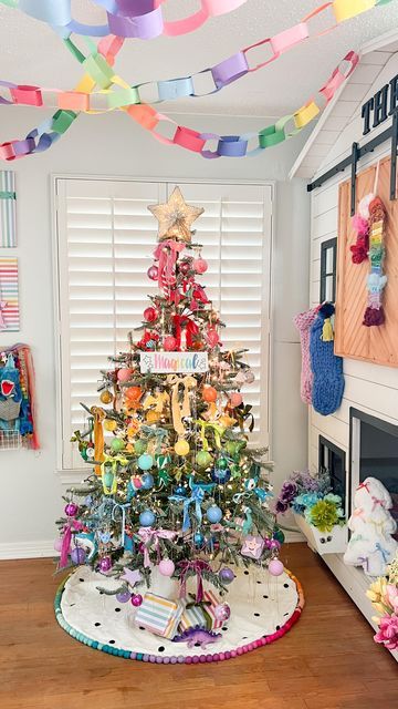 Tina Green | TheBearAndTheFawn on Instagram: "Theo’s bedroom reveal!! 🎄🌈 A rainbow holiday room for my rainbow loving boy! I’ll share a closer look at details soon, but hope you love this as much as we do! I can’t think of a happier space for the holidays💖 Tree: @kingofchristmas Candy cane wreath: @dollartree diy inspired by @ambusheedwithboys & @opal_auktober Magical sign: @chalkdesignsbyme Rainbow garland: @pearlandjane x @kelseyklos collab Tree topper: @michaelsstores Guitar: @loogguitars Flowers: @dollartree Rainbow fabric blanket : @joann_stores Velvet ribbon: @etsy and @anthropologie Stockings: @target last year #rainbowchristmas #colorfulchristmas #christmasinspiration #holidaydecor #kidsholiday #rainbow #colorfuldecor" Rainbow Baby Christmas Tree, Rainbow Tree Decorations, Rainbow Christmas Tree Ornaments, Rainbow Xmas Tree, Pastel Rainbow Christmas, Anthropologie Stockings, Rainbow Christmas Tree Ideas, Rainbow Christmas Tree Decorations, Rainbow Christmas Decor