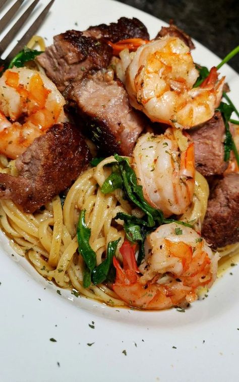 A plate of Steak and Shrimp Linguine Scampi with a glass of white wine, garnished with fresh parsley. Steak And Shrimp Scampi, Steak Shrimp, Shrimp Linguine, Shrimp Fettuccine, Easy To Cook Meals, Steak And Shrimp, Shrimp Recipes For Dinner, Surf And Turf, Food Easy