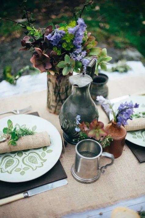 a rustic table inspired by hobbits, with green aptterned plates, burlap, leather and simple blooms Middle Earth Wedding, Hobbit Wedding, Earth Wedding, Elvish Wedding, Lotr Wedding, Elven Wedding, Wedding Goblets, Branch Centerpieces, Bridal Editorial