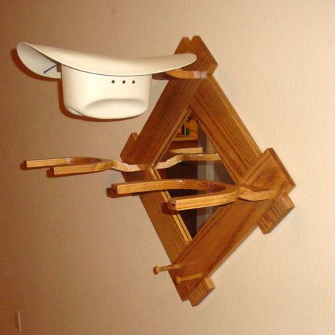 https://www.etsy.com/listing/64397295/wooden-cowboy-western-hat-rack-stand?ref=shop_home_feat Handcrafted,  beautiful crafted hat racks I have designed to keep them looking there best all the time.  This is my Unique Western Style Cowboy Hat Rack w/Mirror & pegs. It's made of Select White Pine Finished with a Min-wax Puritan Pine Stain & a Semi Gloss Polyurethane. Has a 11"x11" Mirror in the center. Wooden Hat Rack, Display Rack Ideas, Cowboy Hat Holder, Hat Rack Ideas, Wall Hat Racks, Diy Hat Rack, Cowboy Hat Rack, Chair Woodworking Plans, Wall Hats