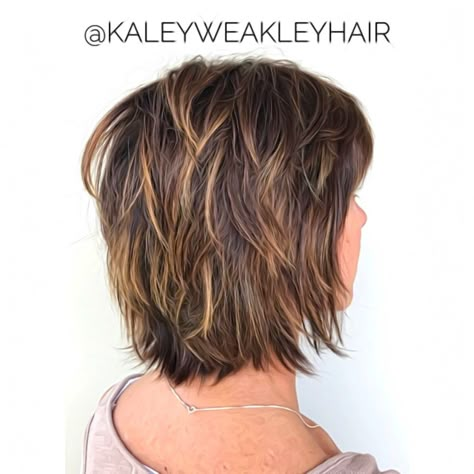 Those not keen on voluminous stacked bobs should try shags. Short textured hair replaces the height at the crown of the head with a uniform shaggy length. Incorporating shorter layers achieves the sought-after ragged appearance. Pro tip—highlighting them with blonde balayage gives extra definition! Two Layer Haircut Short, Shaggy Medium Bob For Fine Hair, Short Textured Haircuts For Thick Hair, Textured Bob Haircut With Bangs, Low Maintenance Hairstyles For Fine Hair, Hair Styles Fine Hair Over 50, Feathered Bob With Bangs, Med Shag Hairstyles, Edgy Shag Haircut