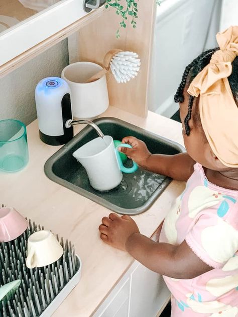 Play kitchens are a staple in almost every household, but if you want to take things up a notch, try making a functional toddler kitchen, it's easier than you Play Kitchen Functional Sink, Ikea Toy Kitchen Hack Montessori, Ikea Play Kitchen Running Water Hack, Play Kitchen With Running Water, Montessori Ikea Kitchen Hack, Kids Ikea Kitchen Hack, Ikea Play Kitchen Hack Functional, Ikea Functional Play Kitchen, Kids Functional Kitchen