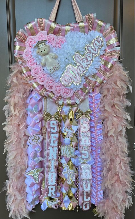 Mums Homecoming Junior Year, Wrestling Homecoming Mum, Heart Mums Homecoming Pink, Mum Homecoming Senior, Senior Hoco Mums Pink, Pink And Gold Mums Homecoming, Senior Mums Homecoming White And Purple, Sophomore Hoco Mum, Pink And Gold Homecoming Mum