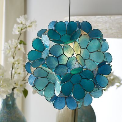 Symbolizing purity while providing pure brilliance, our Daisy Capiz Pendant Light is a shimmering natural. The source of its beautiful blue glow? Capiz shells painted aqua and teal then hand-formed into floral blooms. You know where to hang it—over your dining table, patio or powder room sink. Capiz Pendant Light, Aqua Pendant, Powder Room Sink, House Of Turquoise, Indoor Patio Furniture, Soothing Colors, Pier 1 Imports, Pier 1, Beautiful Interiors