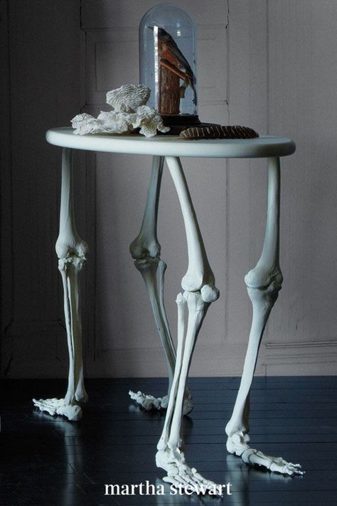 Frankenstein saw inspiration in the most grotesque of scavenging-here we took a note from his book and constructed a bones table decoration for spooky DIY Halloween home decor. To make it, follow our tutorial using a few supplies for this decorative Halloween bone table. #marthastewart #halloween #halloweendecor #diyideas #diyhalloween #halloweenlivingroom Skeleton Table, Martha Stewart Holiday, Halloween Fest, Skeleton Bones, Diy Halloween Projects, Goth Home, Goth Home Decor, Cabinet Of Curiosities, A Skeleton