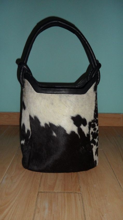 Our Brown And White Cowhide Tote Bag  is casual sophistication at it's best! Luxurious inside and out made of supple  leather and premium hair on hide. You will look and feel great carrying this functional piece of art.   This is a unique and classy hair on cowhide bag all in one. It is made with exquisite craftsmanship and will last for years to come. Let us warn you! You will receive many stops and compliments carrying this handbag. Go ahead and treat yourself! You will NOT be disappointed. Bucket Bag Style, Classy Hair, Purse Style, Cowhide Purse, Western Cross, Cowhide Handbags, Fur Purse, Bucket Purse, Cowhide Bag