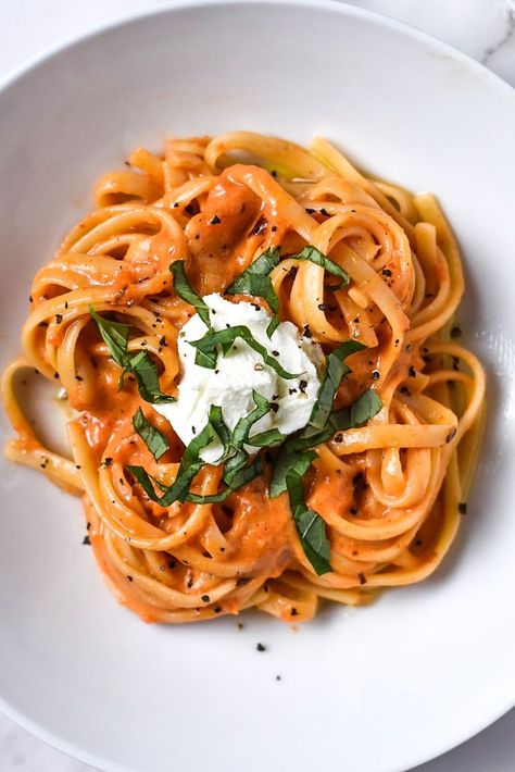 A shallow white bowl filled with roasted red pepper pasta topped with a dollop of ricotta, black pepper, and fresh basil. The background is an off white textured cloth. Toasted Red Pepper Pasta, Roasted Red Pepper Pasta, Red Pepper Pasta, Basil Pasta, Pepper Pasta, Roasted Red Pepper, Roasted Peppers, Pepper Sauce, Food Photography Styling