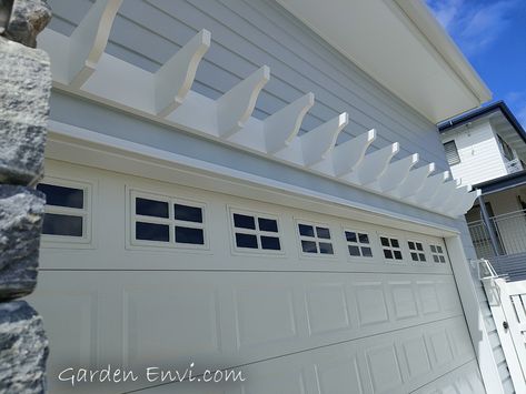 This Eyebrow Pergola looks simply beautiful on this residence in Moffat Beach. What a beautiful house and the size and placement of the eyebrow pergola looks just perfect. View more pictures and details - https://gardenenvi.com/eyebrow-pergola-with-ogee/ #Pergola #PergolaCaloundra #EyebrowPergola #GaragePergola #PrettyPergola #WhitePergola #HamptonStyle #HamptonsStylePergola #GardenEnvi Eyelash Pergola Garage, Modern Pergola Over Garage Door, Eyebrow Pergola Over Window, Garage Eyebrow, Garage Eyebrow Pergola, Pergola Above Garage Door, Eyebrow Pergola, Diy Eyebrow, Single Garage