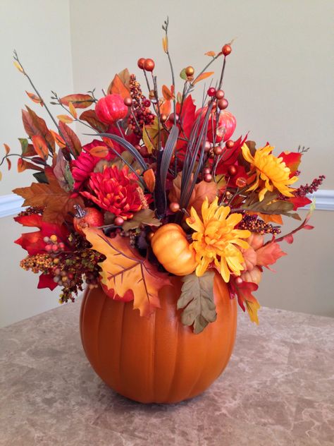 Small pumpkin floral arrangement. #fall #flowers #berries #leaves #thanksgiving #ImCrafty #green #brown #orange #red #beautiful #pumpkin Pumpkin Vase Flowers, Oumpkin Flower Areangnent, Thanksgiving Faux Flowers, Fall Pumpkin Flower Centerpiece, How To Make Pumpkin Flower Centerpiece, Thanksgiving Floral Arrangements, Pumpkin Floral Arrangements, Thanksgiving Floral, Pumpkin Vase