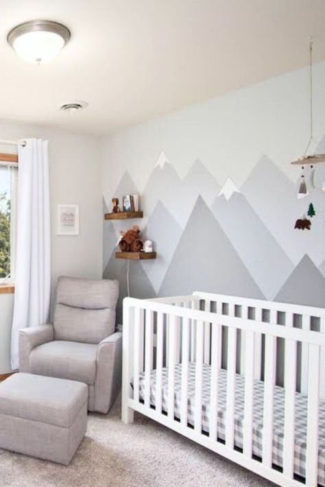 The Baby nursery has a gray mountain mural behind a crib and chair. Mountain Nursery Theme, Baby Boy Nursery Room Design, Baby Nursery Inspiration, Mountain Nursery, Cool Kids Bedrooms, Baby Room Neutral, Baby Room Themes, Baby Nursery Neutral, Nursery Room Design