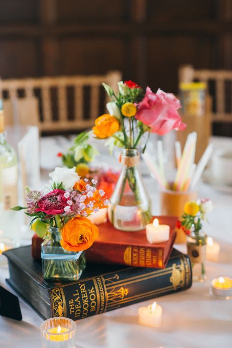 Short #reception #centerpiece with books as flower vase stand - babb photo Book Wedding Centerpieces, Historic Library, Flowers In Vases, Unique Wedding Centerpieces, Book Centerpieces, Jenny Smith, Book Themed Wedding, Colorful Centerpieces, Literary Wedding