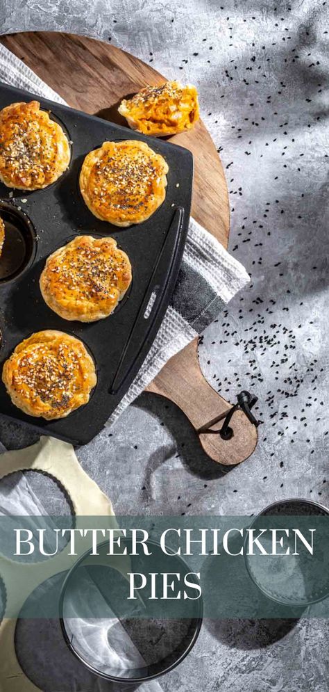 Butter chicken pies in a muffin pan on top of a wooden chopping board. Butter Chicken Pie Recipe, Butter Chicken Pot Pie, Butter Chicken Pie, Mini Savory Pies, Mini Hand Pies, Homemade Butter Chicken, Creamy Butter Chicken, Chicken Pies, Mini Pie Recipes