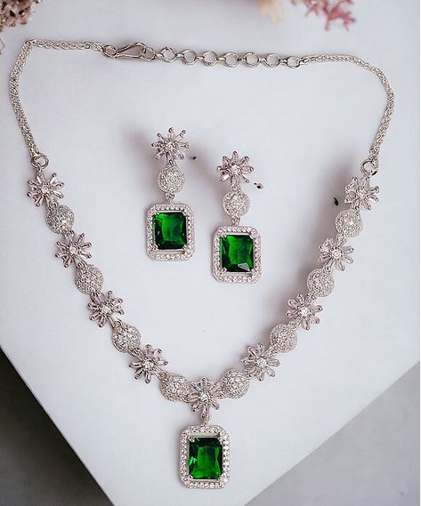 Introducing our exquisite green necklace and earrings set, a perfect accessory to elevate your style. This elegant ensemble, adorned with American diamond embellishments, exudes an air of sophistication and glamor. Inspired by the iconic Celebrities, this celebrity-inspired jewelry set showcases a beautiful shade of green that complements a variety of outfits and occasions. Crafted with precision and attention to detail, this necklace and earrings set is sure to be a showstopper and enhance your overall look.  You can wear your jewellery with confidence, knowing that each Electrifying Jewellery piece comes with a manufacturing warranty and a satisfaction guarantee. MATERIAL: Environmental Brass Alloy with Top Quality Genuine Plating, World-class Craftsmanship, TSB Collection makes people r Ad Bridal Jewellery Set, Iconic Celebrities, Jewelry Ads, Designer Necklace, Diamond Jewelry Designs, Cz Necklace, Fancy Jewellery, Necklace And Earrings Set, Wedding Jewellery Necklace