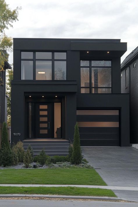 Modern black stucco house facade with bold architectural lines. Check out all of these sleek and stylish dark modern house ideas that blend sophistication with a touch of mystery. Modern Contemporary Exterior House Colors, Modern New Build House, All Black Exterior House Modern, Morden Black House, Modern 3 Story House Exterior, Black Building Exterior, Black Stucco House, Concrete House Design Exterior, Medium Modern House