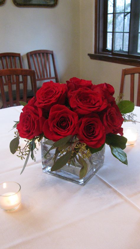 Simple and elegant red rose centerpiece Elegant Red Rose Centerpieces, Roses Centerpieces Quinceanera, Small Red Rose Centerpiece, Red And Green Centerpieces, Wedding Centerpieces Red Roses, Rose Centerpieces Simple, Red Flower Table Centerpieces, Rose Centerpieces Quinceanera, Red Wedding Centerpieces Elegant