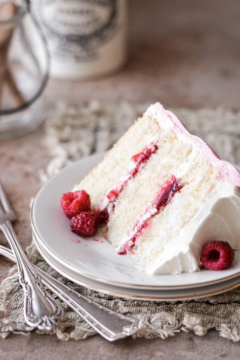 Three layers of fluffy vanilla cake with raspberry jam filling, vanilla buttercream and raspberry buttercream, in a high altitude tested recipe. Raspberry Vanilla Cake, Chocolate Buttercream Cake, Miniature Desserts, White Chocolate Raspberry Cake, Cake With Raspberries, High Altitude Baking, White Chocolate Buttercream, Raspberry Buttercream, White Chocolate Cake