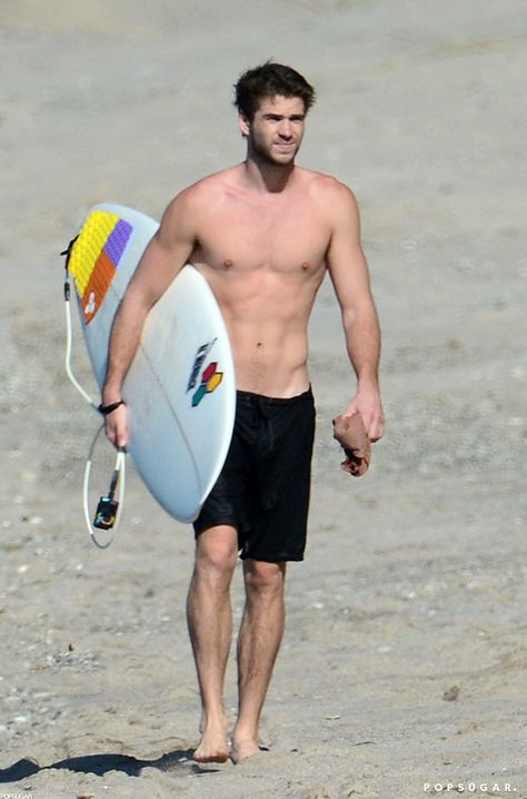 Pin for Later: Jet Set With the Best Celebrity Vacations  Liam Hemsworth carried his surfboard on the beach in Costa Rica in January 2013. Celebrity Abs, Hemsworth Brothers, Celebrity Bodies, Surfer Dude, Liam Hemsworth, Hot Actors, Shirtless Men, Chris Hemsworth, Celebrities Male