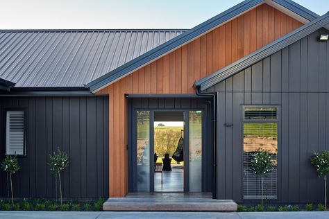 Black Outside House, Black And Wood Exterior House Modern, Vertical Vs Horizontal Siding, Black Homes With Wood Accents, Dark Vertical Siding, Black Hardie Board Siding, Metal Siding With Stone, Gray House With Wood Accents Exterior, Hardie Board Siding Ideas Modern