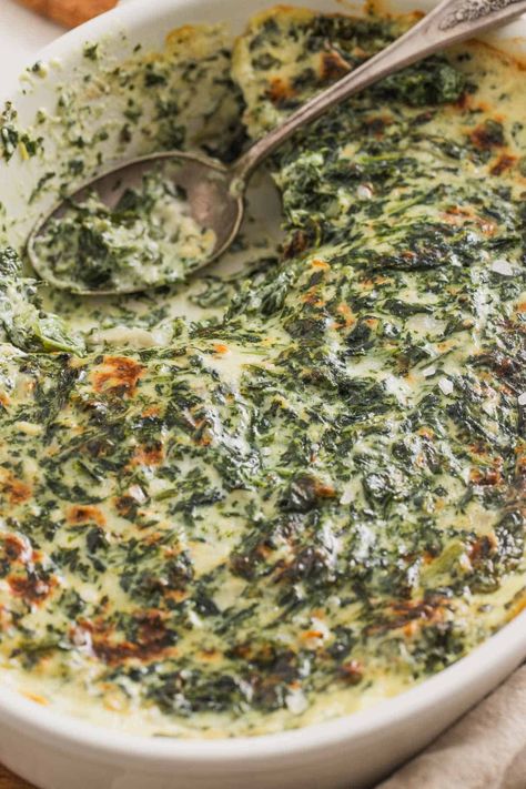 This creamed spinach from frozen spinach is a steakhouse-style recipe that's baked at the end in a casserole dish. It's made without heavy cream but in a creamy, cheesy sauce. It's the perfect side dish for Thanksgiving, Christmas, or holidays and it feeds 8-10 people as written, but can be decreased for a smaller group. The perfect winter potluck dish! Spinach Heavy Cream Recipes, Southern Creamed Spinach, Creamy Spinach Casserole, Creamy Spinach Bake, Creamy Spinach Recipe, Wilted Spinach Recipes, Creamed Spinach Recipe Fresh, Boursin Creamed Spinach, Spinach Madeline Recipes